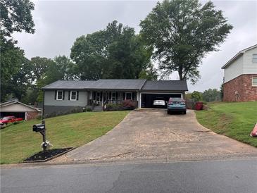 Charming single Gathering home with a well manicured lawn, long driveway and attached garage at 2298 Hillbriar Dr, Buford, GA 30518
