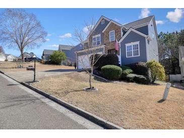 Charming two-story home with a well-manicured lawn and inviting curb appeal in a suburban neighborhood at 537 Autumn Ridge Dr, Canton, GA 30115