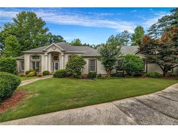 Stunning single-story home with a lush green lawn and mature landscaping at 3018 Saint Andrews Ct, Jonesboro, GA 30236