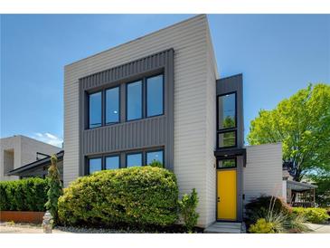 Modern two-story home featuring large windows, and a bright yellow front door at 53 Daniel Se St, Atlanta, GA 30312