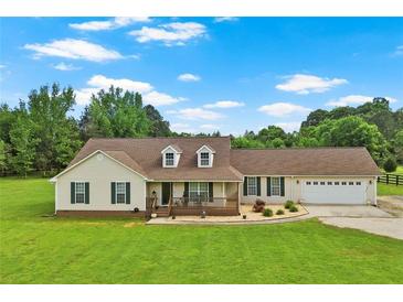 Charming ranch-style home featuring a welcoming front porch and an attached two-car garage with a well-manicured front lawn at 24 Fossetts Nw Cv, Cartersville, GA 30121