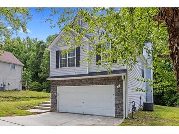 Charming two-story home featuring a two-car garage and traditional curb appeal at 9511 Rollinghills Dr, Jonesboro, GA 30238