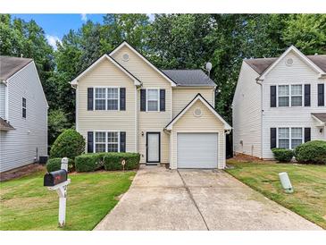 Charming two-story home with a well-maintained lawn and attached one car garage at 26 Springbottom Dr, Lawrenceville, GA 30046