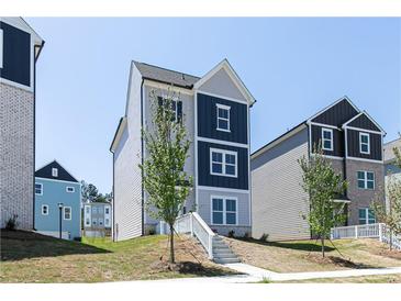 Charming three-story home with blue and gray siding and a well-maintained front yard at 2719 Stream Valley Lane Nw Nw Cir, Atlanta, GA 30318