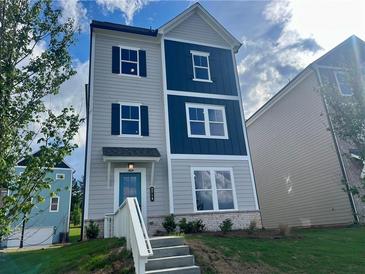 Charming two-story home featuring a blue front door, gray siding, and dark blue accents at 2719 Stream Valley Lane Nw Nw Cir, Atlanta, GA 30318
