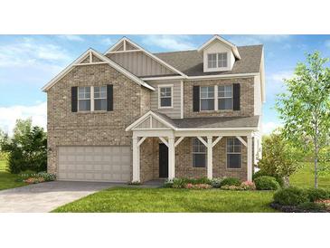 Charming two-story home features a brick facade, a covered porch, and an attached two-car garage at 3198 Shirecrest Ln, Dacula, GA 30019