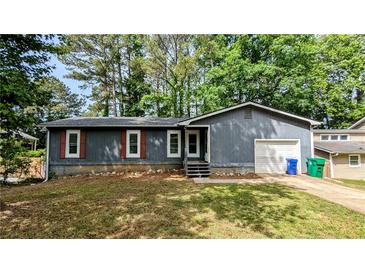 Charming single-story home with gray siding, brown shutters, and a well-maintained front yard at 1182 Demere Dr, Stone Mountain, GA 30083