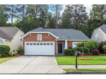 Charming brick home featuring a well-manicured lawn and an attached two-car garage in a beautiful neighborhood at 2319 Alnwick Dr, Duluth, GA 30096