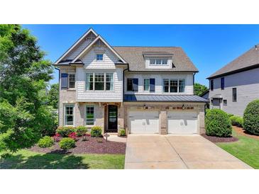 Charming two-story home featuring a mix of brick and shingle siding, plus an attached two car garage at 3910 Cameron Ct, Cumming, GA 30040