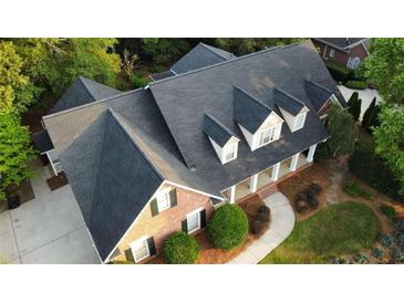 Aerial view of stunning home with a well manicured yard and mature shade trees at 328 Broadmoor Way, Mcdonough, GA 30253