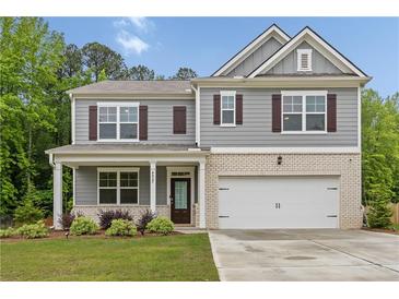 Two-story home features gray siding, brick accents, and a two-car garage at 4827 Golden Finch Ln, Powder Springs, GA 30127