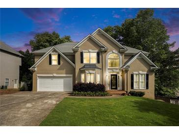 Stunning two-story home boasting well-manicured lawn, two-car garage, and inviting front entrance at 5215 Tealing Ne Dr, Roswell, GA 30075