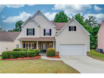 Charming two-story home with a well-manicured lawn and a two-car garage at 2725 Sedgeview Way, Buford, GA 30519