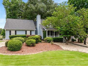 Charming home featuring a well-maintained lawn and mature landscaping, creating an inviting curb appeal at 2790 Shiloh Way, Snellville, GA 30039