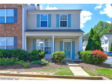 Charming two-story home featuring a welcoming front porch, tidy landscaping, and attractive curb appeal with blue shutters at 10900 Wittenridge Dr # L6, Alpharetta, GA 30022
