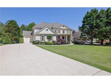 Beautiful two-story home featuring a long driveway, well-manicured lawn, and lovely landscaping at 3735 Duckcove Way, Cumming, GA 30041