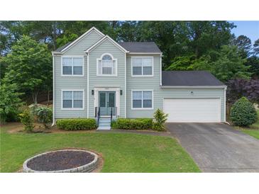 Charming two-story home with a well-manicured lawn and attached two-car garage at 5859 Bellingrath Way, Lithonia, GA 30058