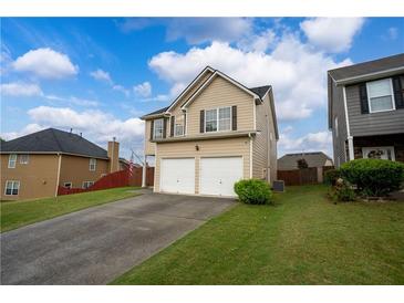 Inviting two-story home with a two-car garage, well-maintained lawn, and an ample driveway at 4015 Arch Pass, Cumming, GA 30040
