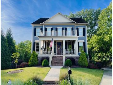 Charming two-story home with a welcoming front porch and second-story balcony at 1205 Renaissance Se Ct, Mableton, GA 30126