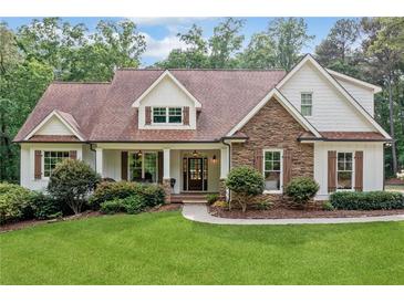 Charming home with stone accents, manicured lawn, and inviting front porch at 1825 Epperson Rd, Canton, GA 30115