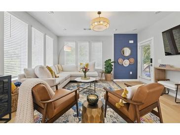 Bright living room with stylish furnishings, hardwood floors, and abundant natural light from large windows at 407 Pratt Se Dr # 1101, Atlanta, GA 30315