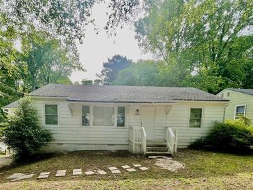 Charming single-story home featuring a traditional design and a well-maintained front yard at 1440 Kenilworth Sw Dr, Atlanta, GA 30310
