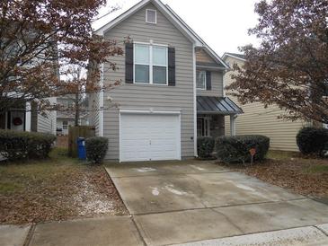 Charming two-story home featuring a one-car garage and a cozy front porch with stone accents at 2019 Briar Creek Ne Ct, Conyers, GA 30012