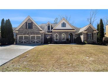 Charming single-story home boasts a brick facade, arched windows, and a well-manicured front lawn at 448 Hanover Drive, Villa Rica, GA 30180