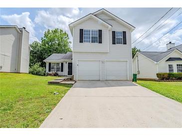 Charming two-story home featuring a two-car garage and well-maintained front yard at 4889 Hidden Creek Pl, Decatur, GA 30035