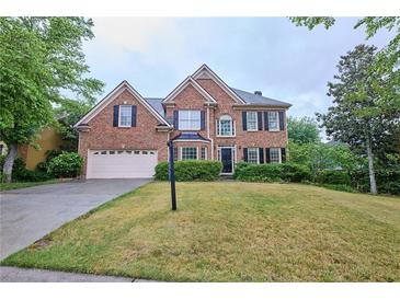 Beautiful two-story brick home with a well-manicured lawn and attached two-car garage at 1425 Turtle Dove Ln, Lawrenceville, GA 30043
