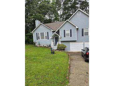 Charming two-story home with a well-manicured lawn, attached garage and a welcoming front entrance at 144 Boones Ridge Se Pkwy, Acworth, GA 30102
