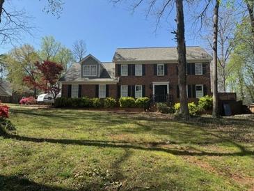 Charming two-story home with manicured lawn and traditional architecture at 1153 Staples Sw Dr, Lilburn, GA 30047