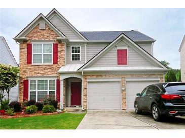 Charming two-story home with stone accents, red shutters, and attached two-car garage at 634 Friars Head Dr, Suwanee, GA 30024