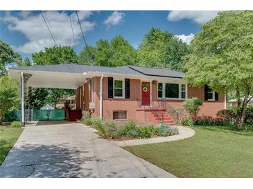 Charming brick home with a covered carport and beautifully landscaped front yard at 243 Woodview Ln, Smyrna, GA 30082