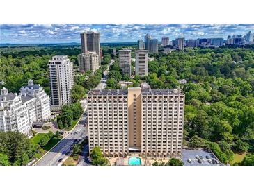 Stunning aerial view showcasing a luxury high-rise condo building amidst lush greenery and a vibrant cityscape at 2479 Peachtree Ne Rd # 1801, Atlanta, GA 30305