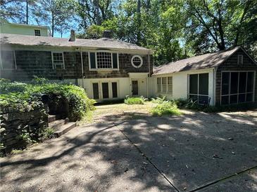Charming home featuring a stone-accented driveway, screened-in porch, and unique architectural details at 181 Eureka Ne Dr, Atlanta, GA 30305