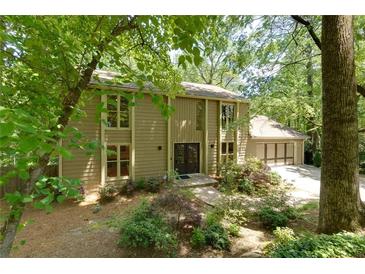 Charming two-story home featuring large windows, a well-maintained yard, and a two-car garage at 1760 Little Willeo Rd, Marietta, GA 30068