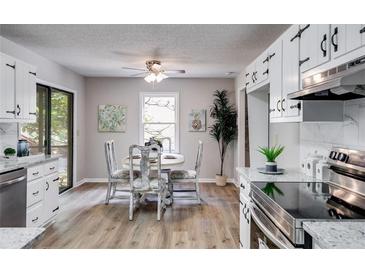 Eat-in kitchen features modern appliances, granite countertops, and hardwood floors at 10213 Tall Pine Ct, Villa Rica, GA 30180