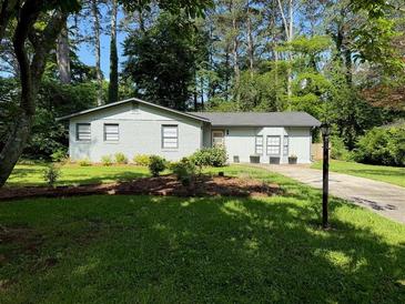 Charming single-story home with a well-maintained lawn and mature trees, offering great curb appeal at 910 Oriole Se Ln, Marietta, GA 30067