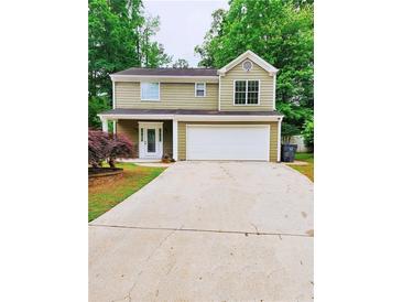 Charming two-story home featuring a spacious two-car garage and a well-manicured lawn at 2320 Glynmoore Dr, Lawrenceville, GA 30043