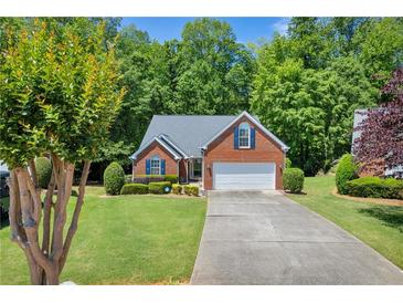 Charming single-story brick home with a well-manicured lawn and attached garage at 415 Stephanie Ct, Stockbridge, GA 30281