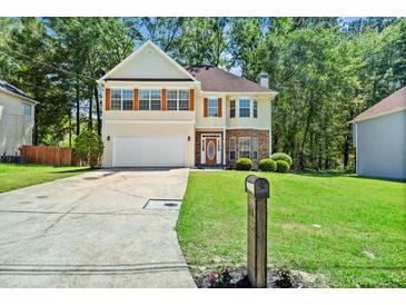 Charming two-story home featuring a well-maintained lawn and attached two-car garage at 740 Marcus Nyah Ct, Atlanta, GA 30349