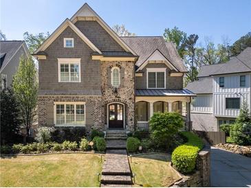 Charming two-story home featuring a combination of stone and shake siding with manicured landscaping at 44 Barbara Ln, Atlanta, GA 30327