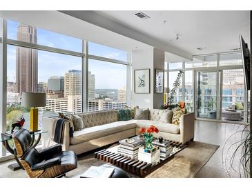Bright living room featuring a comfortable sectional sofa, stylish decor, and floor-to-ceiling windows with city views at 45 Ivan Allen Jr Nw Blvd # 1702, Atlanta, GA 30308