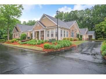 Inviting exterior with manicured landscaping, neutral color palette, and charming architectural details at 2595 Grapevine Cir, Cumming, GA 30041