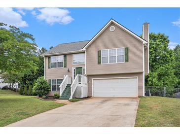 Charming two-story home with green door, well-maintained lawn, and attached two-car garage at 35 Kendall Ln, Covington, GA 30014