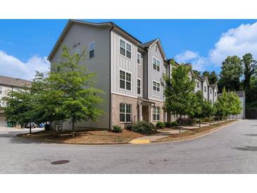View of the townhome's exterior highlighting the architecture, landscaping, and neighborhood charm at 1624 Venture Point Way, Decatur, GA 30032