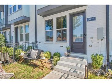 Charming home with a cozy front yard seating area, featuring a bistro set and manicured landscaping at 1007 Katie Kerr Dr, Decatur, GA 30030