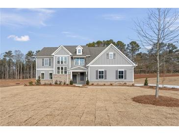 Charming two-story home featuring gray siding, brick accents, and a well-manicured lawn, perfect for curb appeal at 2722 Byess Ct, Marietta, GA 30064