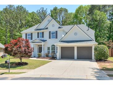 Charming two-story home with a well-manicured lawn and a two-car garage at 229 Brookview Pl, Woodstock, GA 30188